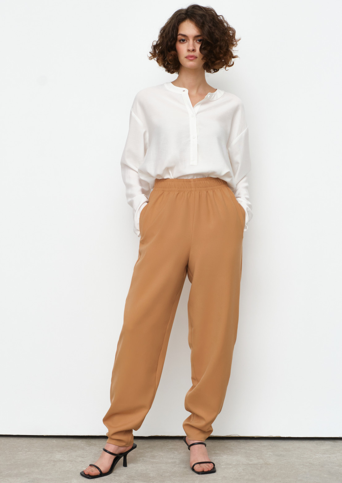 Beige colour tight fabric trousers