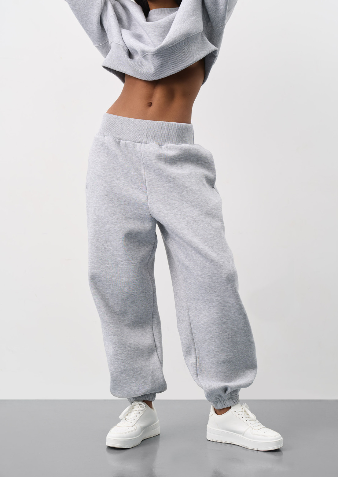 Grey melange color three-thread insulated jogger pants with a wide belt